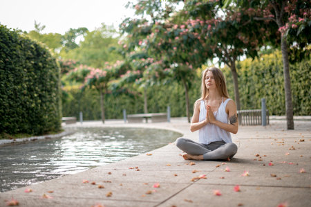 Girl practice yoga meditation outdoor in parkの写真素材