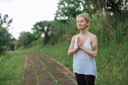 Girl practice yoga meditation outdoor in parkの写真素材