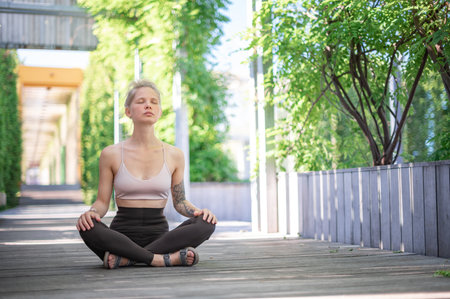 Girl practice yoga meditation outdoor in parkの写真素材