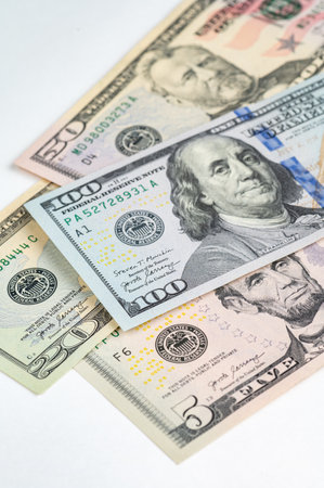 5, 20, 50, 100 dollars banknotes at different angles. Close up of dollars on white background.の写真素材