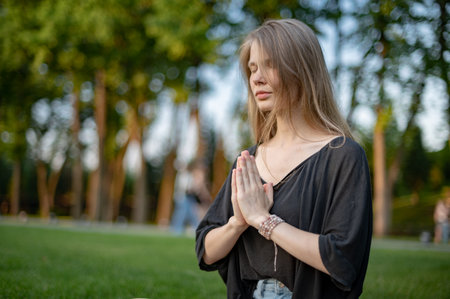 Girl practice yoga meditation outdoor in parkの写真素材