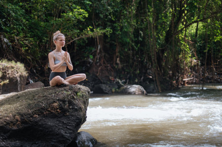Girl practice yoga meditation outdoorの写真素材