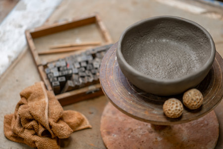 Vintage Crafting Tools for work with clay and Accessories Amidst a Rustic Tableの写真素材