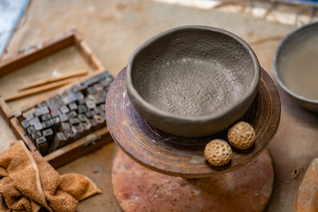Vintage Crafting Tools for work with clay and Accessories Amidst a Rustic Tableの写真素材