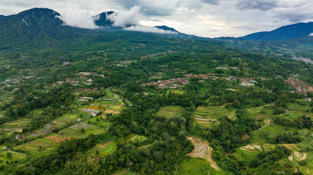 Aerial view of a picturesque village surrounded by lush greenery and stunning landscapesの写真素材