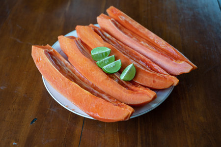 Sliced papaya with lime on tableの写真素材