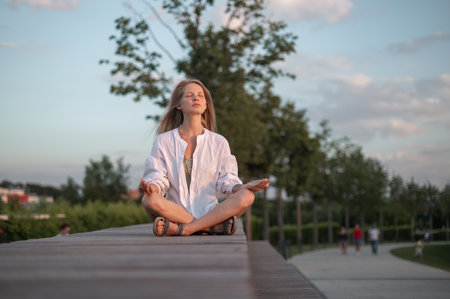 Girl practice yoga meditation outdoor in parkの写真素材
