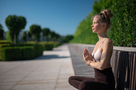 Girl practice yoga meditation outdoor in parkの写真素材