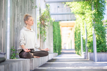 Girl practice yoga meditation outdoorの写真素材