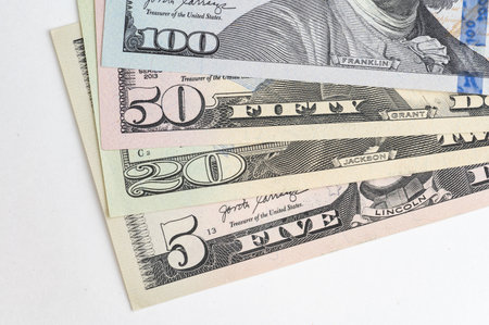 5, 20, 50, 100 dollars banknotes at different angles. Close up of dollars on white background.の写真素材