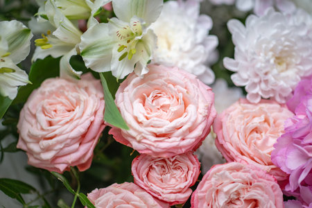 A Stunning Arrangement Featuring a Beautiful Bouquet of Pink and White Roses Alongside Liliesの写真素材