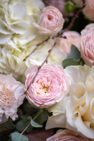 Delicate composition of white and pink roses in a basketの写真素材