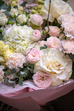 Delicate composition of white and pink roses in a basketの写真素材
