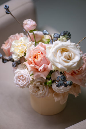 Delicate composition of white and pink roses in a basketの写真素材
