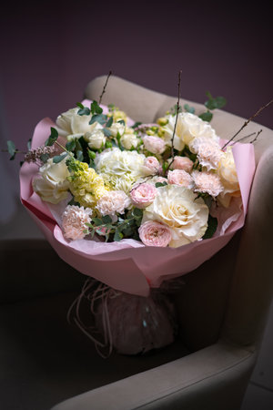 Delicate composition of white and pink roses in a basketの写真素材