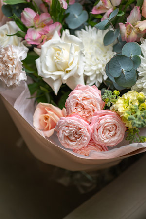 Delicate composition of white and pink roses in a basketの写真素材