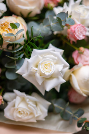 Delicate composition of white and pink roses in a basketの写真素材