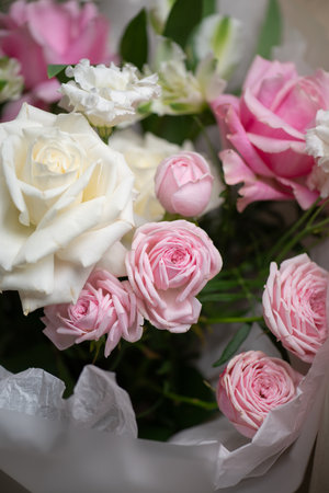 Delicate composition of white and pink roses in a basketの写真素材