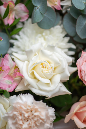 Delicate composition of white and pink roses in a basketの写真素材
