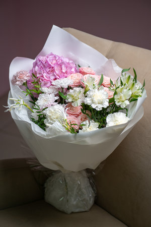 Delicate composition of white and pink flowers in a basketの写真素材