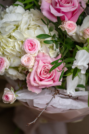 Delicate composition of white and pink roses in a basketの写真素材