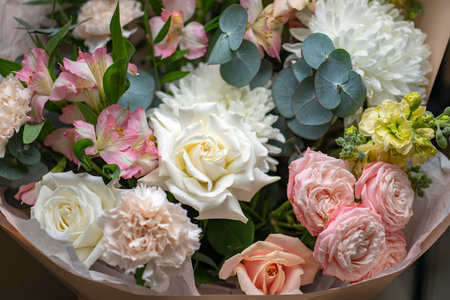 Delicate composition of white and pink roses in a basketの写真素材