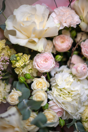 Delicate composition of white and pink roses in a basketの写真素材