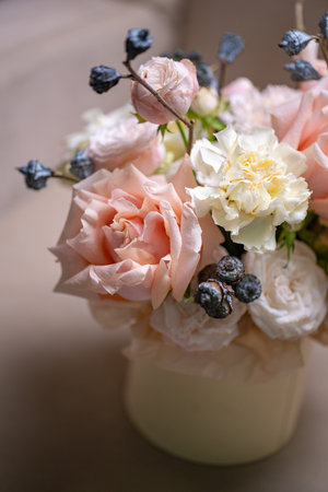 Delicate composition of white and pink roses in a basketの写真素材