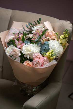 Delicate composition of white and pink roses in a basketの写真素材