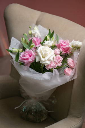 Delicate composition of white and pink roses in a basketの写真素材