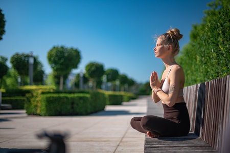 Girl practice yoga meditation outdoor in parkの写真素材