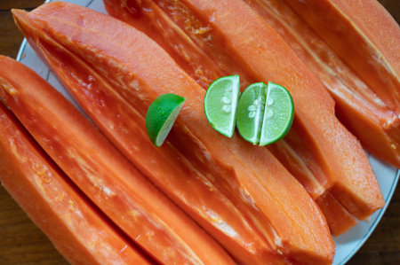Sliced papaya with lime on table
