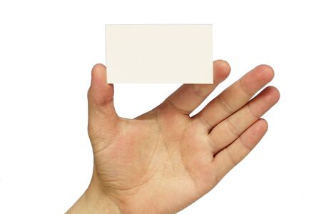 Empty business card in the hand isolated over white backgroundの写真素材