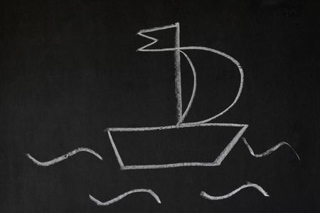 White boat on a blackboard, child chalk drawing stylization の写真素材