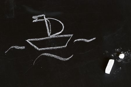 White boat on a blackboard, child chalk drawing stylizationの写真素材