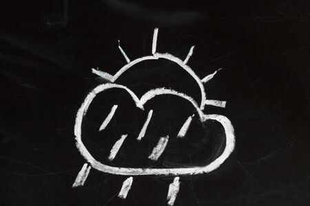 Weather forecast symbol on a blackboard, child chalk drawing stylization の写真素材