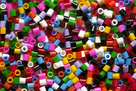 Mixed color plastic particles background macro shotの写真素材