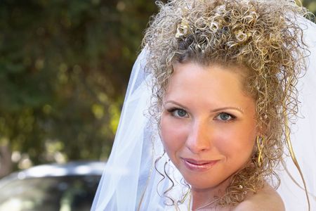 Young happy bride smiling in the parkの写真素材