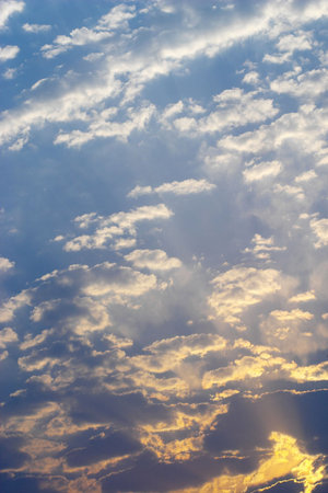 Early evening summer dramatic sky with clouds and sun rays background