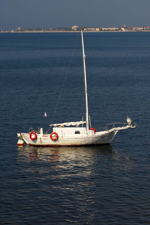 One little white lonely boat in the sea bay