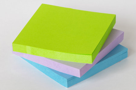 Color sticker notes packs over white paper background