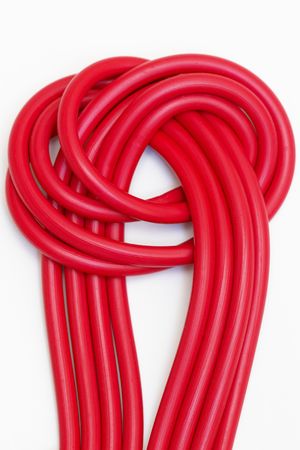 Tie of red plastic wires isolated over white backgroundの写真素材