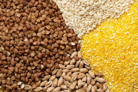 Four sorts of cereals on the black plate macro shot background