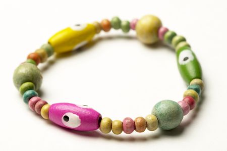 Colored wooden bracelet isolated over white backgroundの写真素材