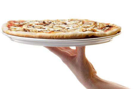 Whole pizza plate on the human hand support isolated over white backgroundの写真素材
