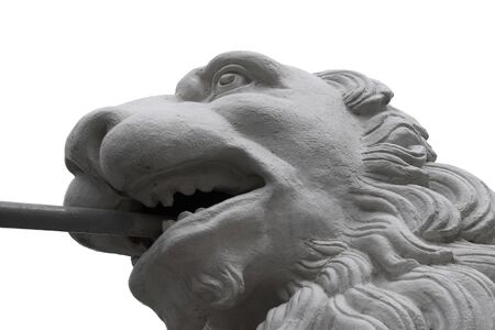 Stone lion fragment with iron in the mouth over white backgroundの写真素材