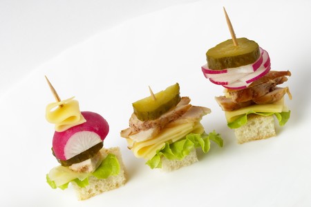 Three small canape snack macro shot isolated over grey gradient backgroundの写真素材