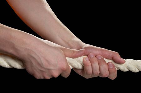Tight the rope with two hands macro shot isolated over black backgroundの写真素材
