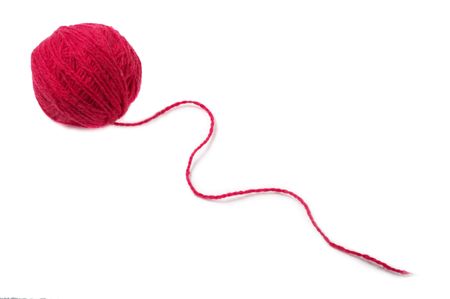 Red thread clew isolated over white background (macro shot)の写真素材