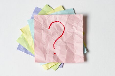 Sticker notes with question sign over white backgroundの写真素材